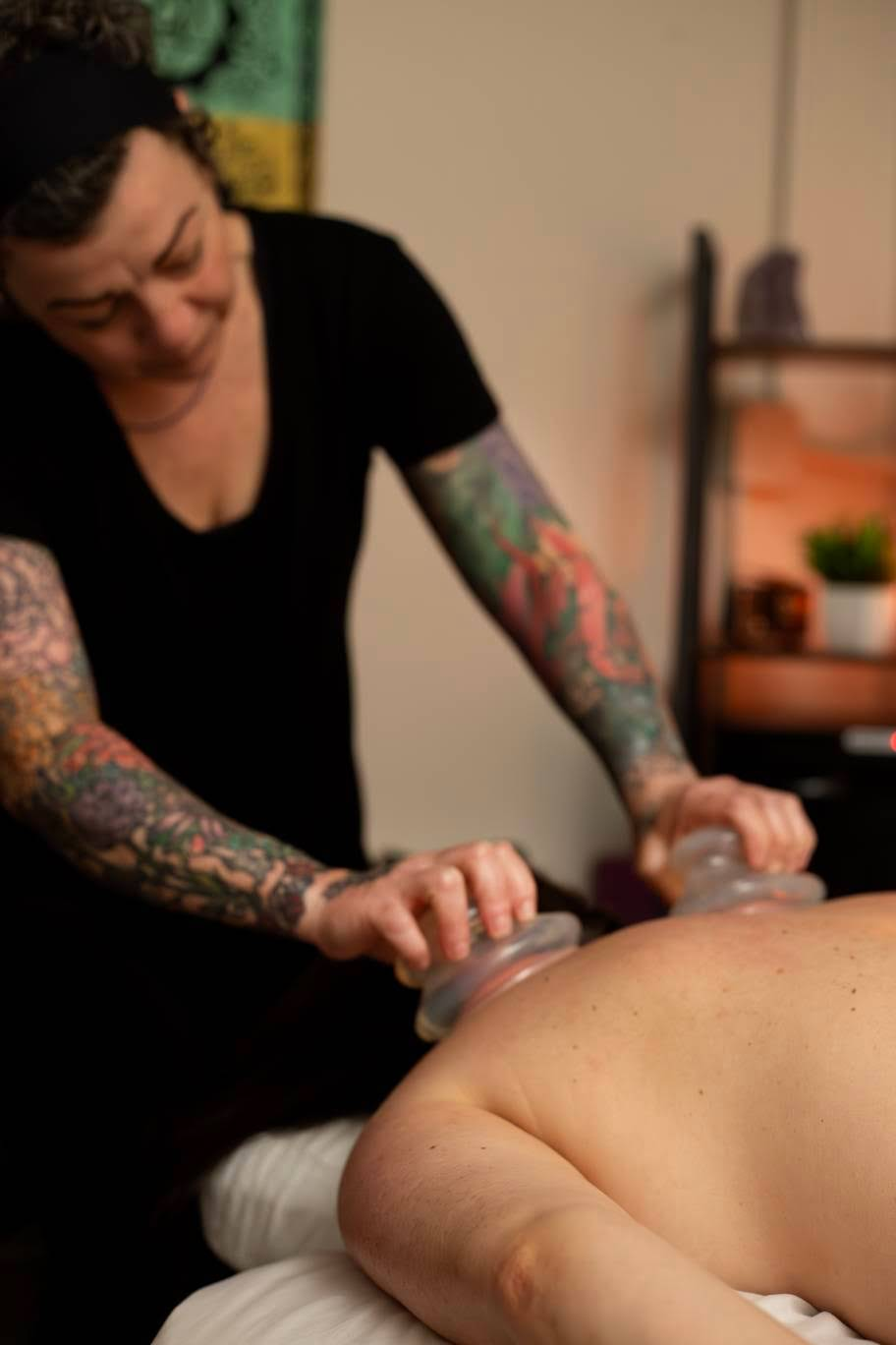 Sacred Strength therapist performing cupping bodywork